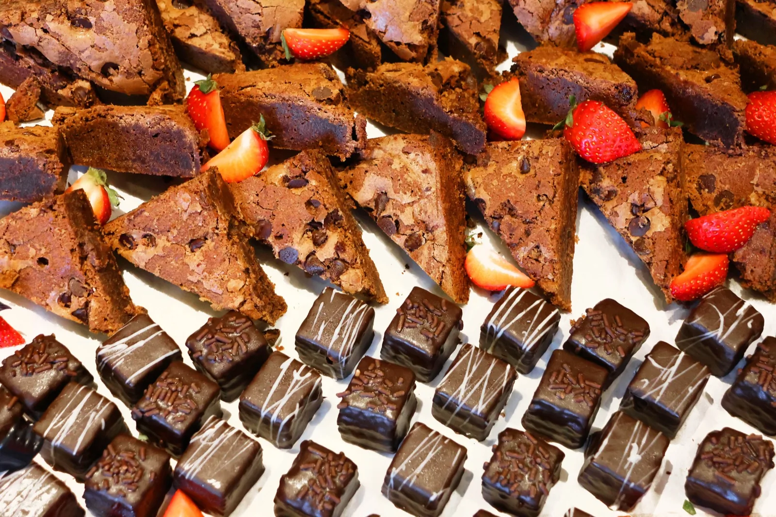 Brownie triangles, chocolate petit fours, and strawberries on the Sunday brunch dessert table at The Venue Clermont
